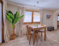 a room filled with furniture and vase of flowers on a table a room filled with furniture and vase of flowers on a table